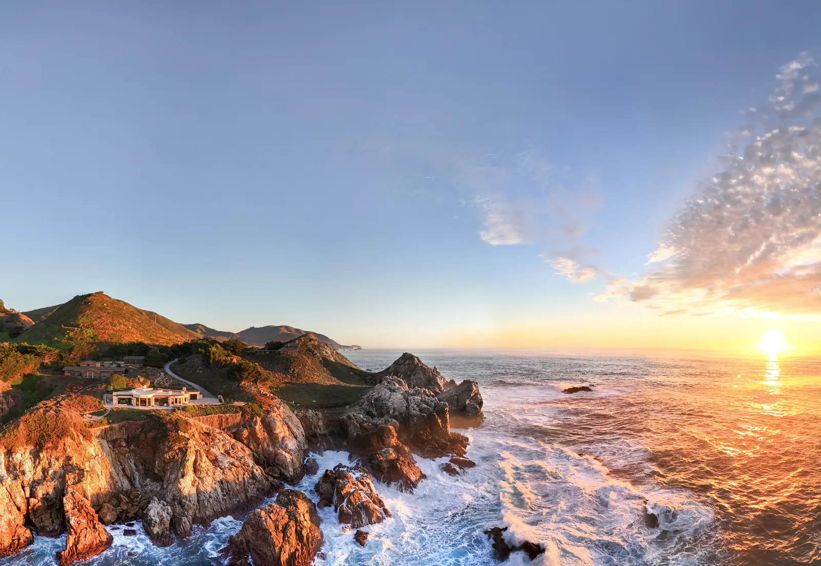 Real estate drone photograph of a home on the Big Sur coast at sunset