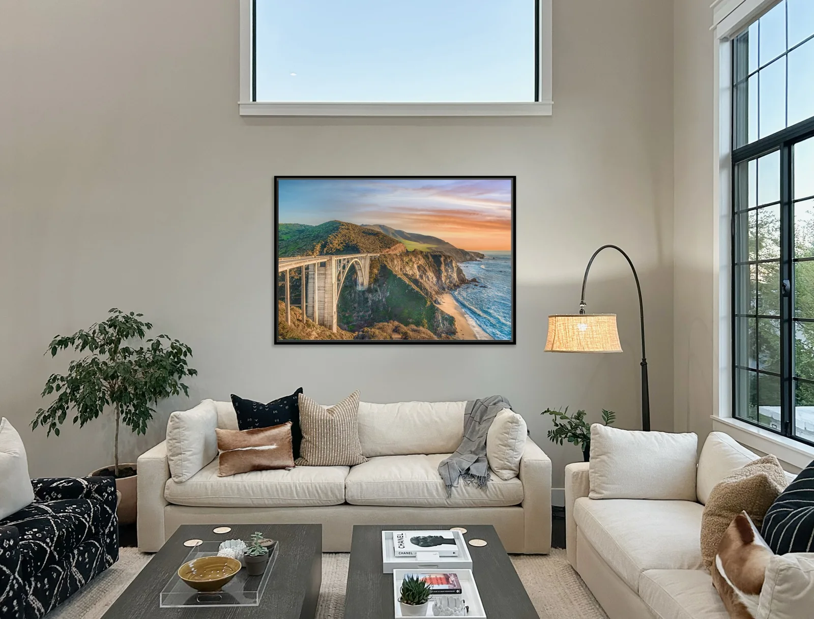 Large framed fine art print of Bixby Creek Bridge at sunset by Manny Espinoza hanging above a sofa in a client's living room on the Monterey Peninsula