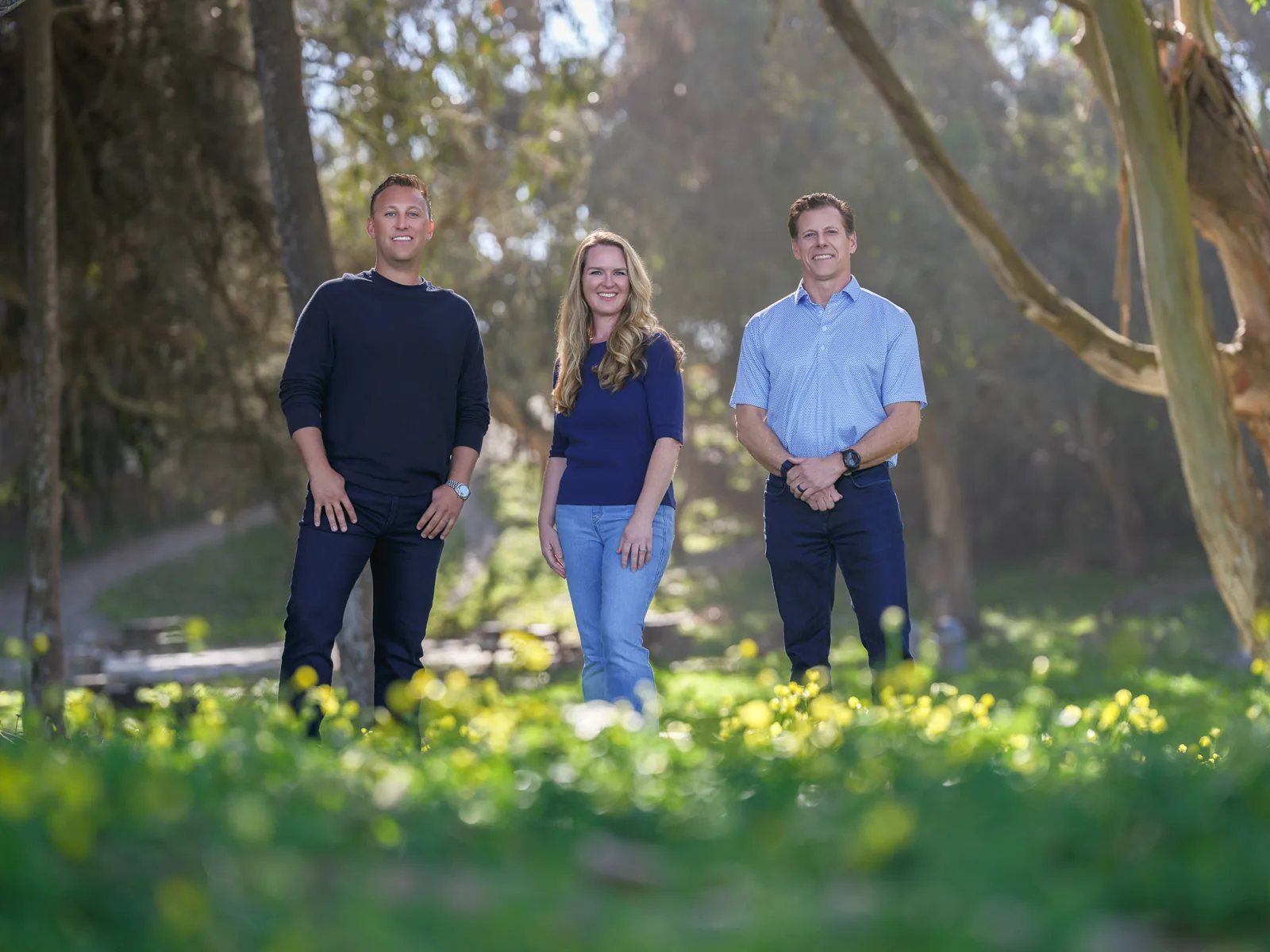 Markus Duran, Kyla Oberman and Joe Barsi of California Giant Berry Farms standing in a grove with wildflowers, portrait for The Snack magazine by Manny Espinoza