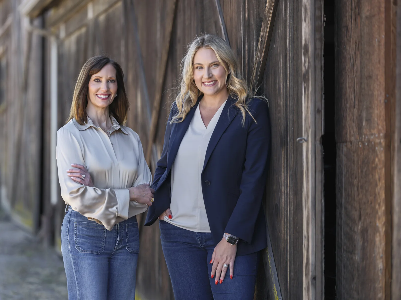 Loree Dowse and Tracy Carranza of Church Brothers Farms in front of a weathered barn, executive portrait for The Snack magazine by Manny Espinoza