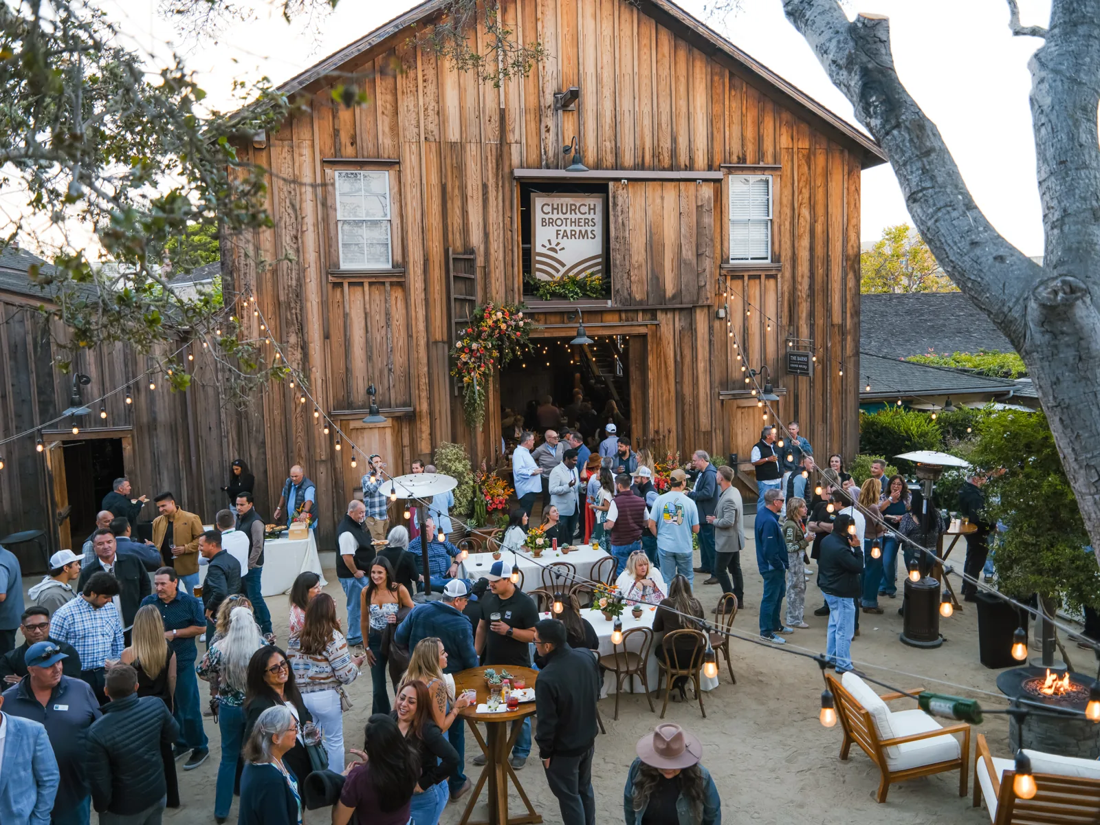 Guests filling the courtyard at The Barns at Cooper Molera for the Church Brothers Farms event, Monterey, by Manny Espinoza
