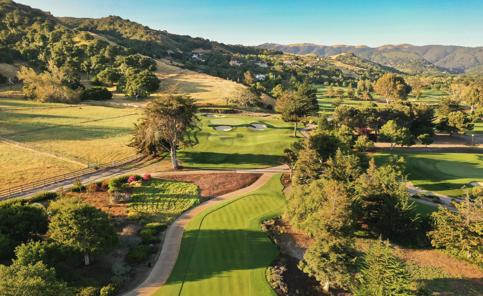 Aerial drone photograph of Corral de Tierra golf course with rolling fairways and oak-dotted hills, by Manny Espinoza