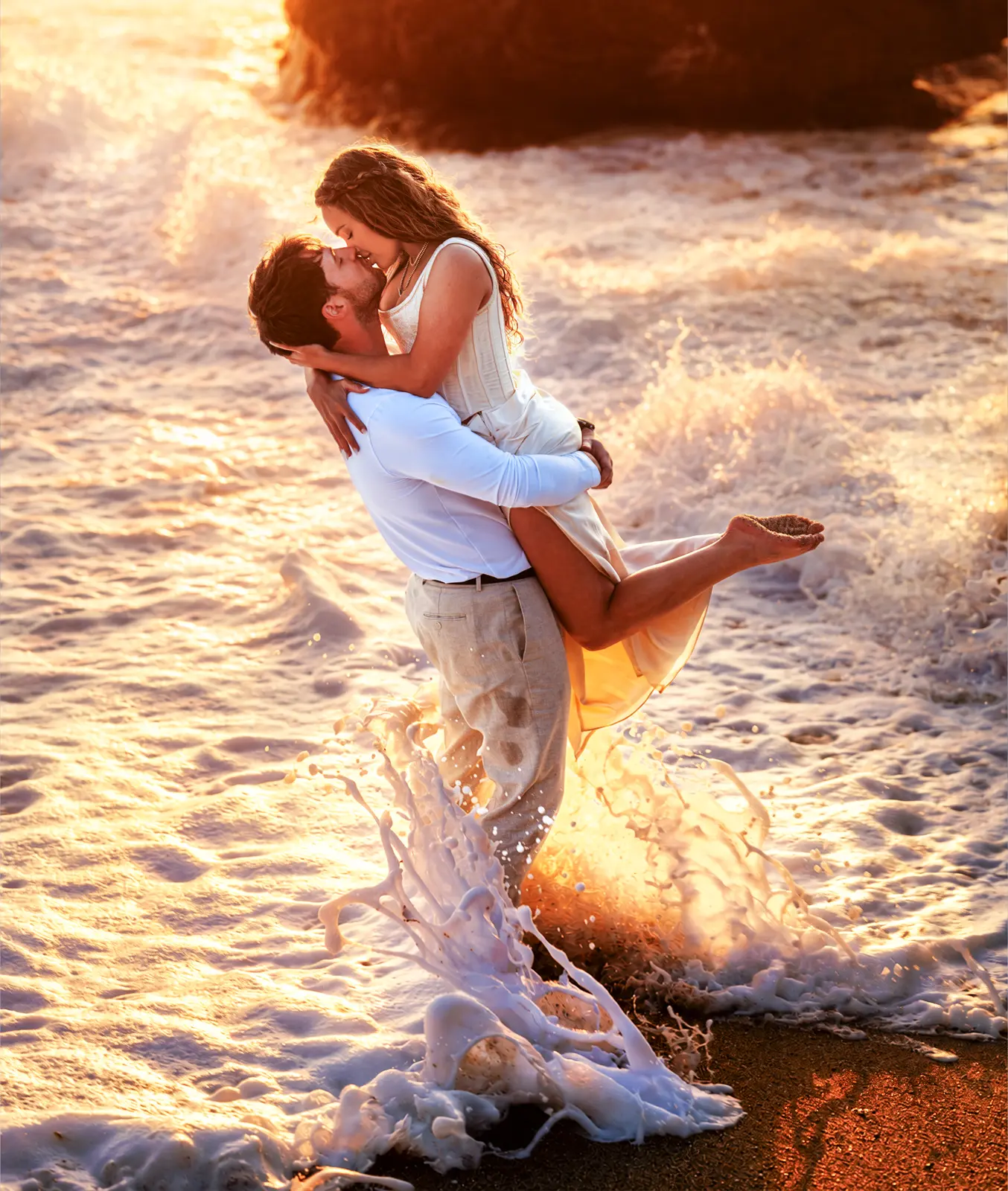 Couple embracing in golden surf on the Carmel coast, photographed by Manny Espinoza