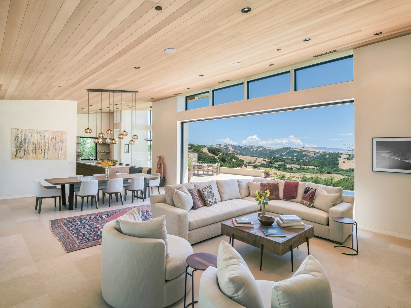 Great room with a wood ceiling and a wall of glass framing the valley view, architectural photography by Manny Espinoza