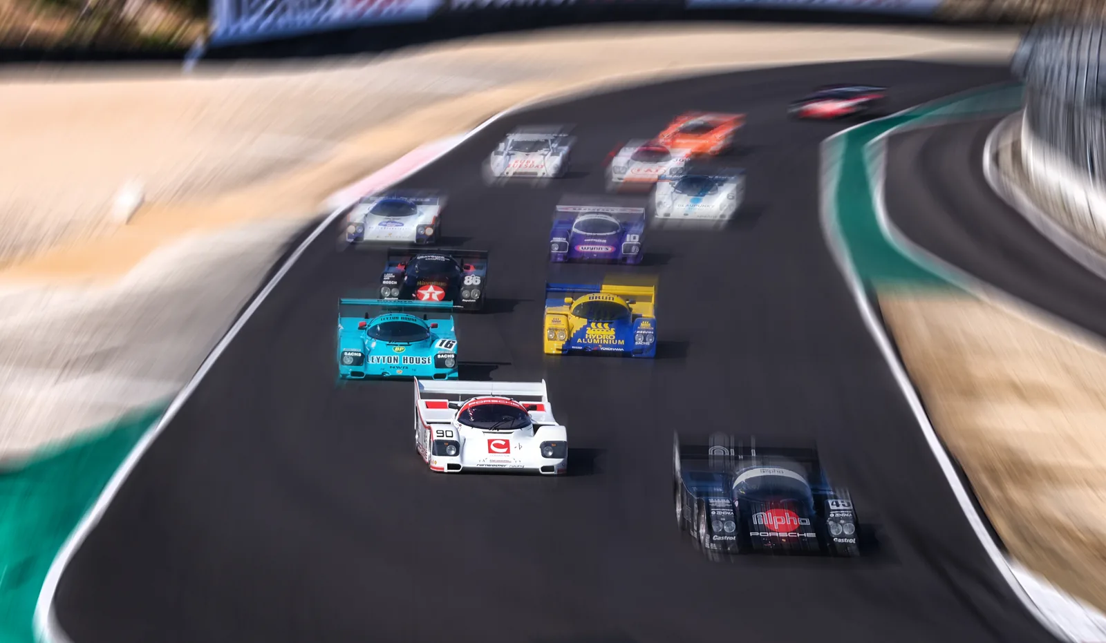 Pack of race cars at the start with panning motion blur, motorsport photography by Manny Espinoza