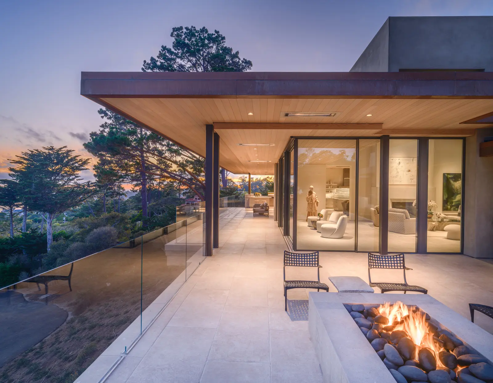 Modern home exterior at twilight with fire terrace on the Monterey Peninsula