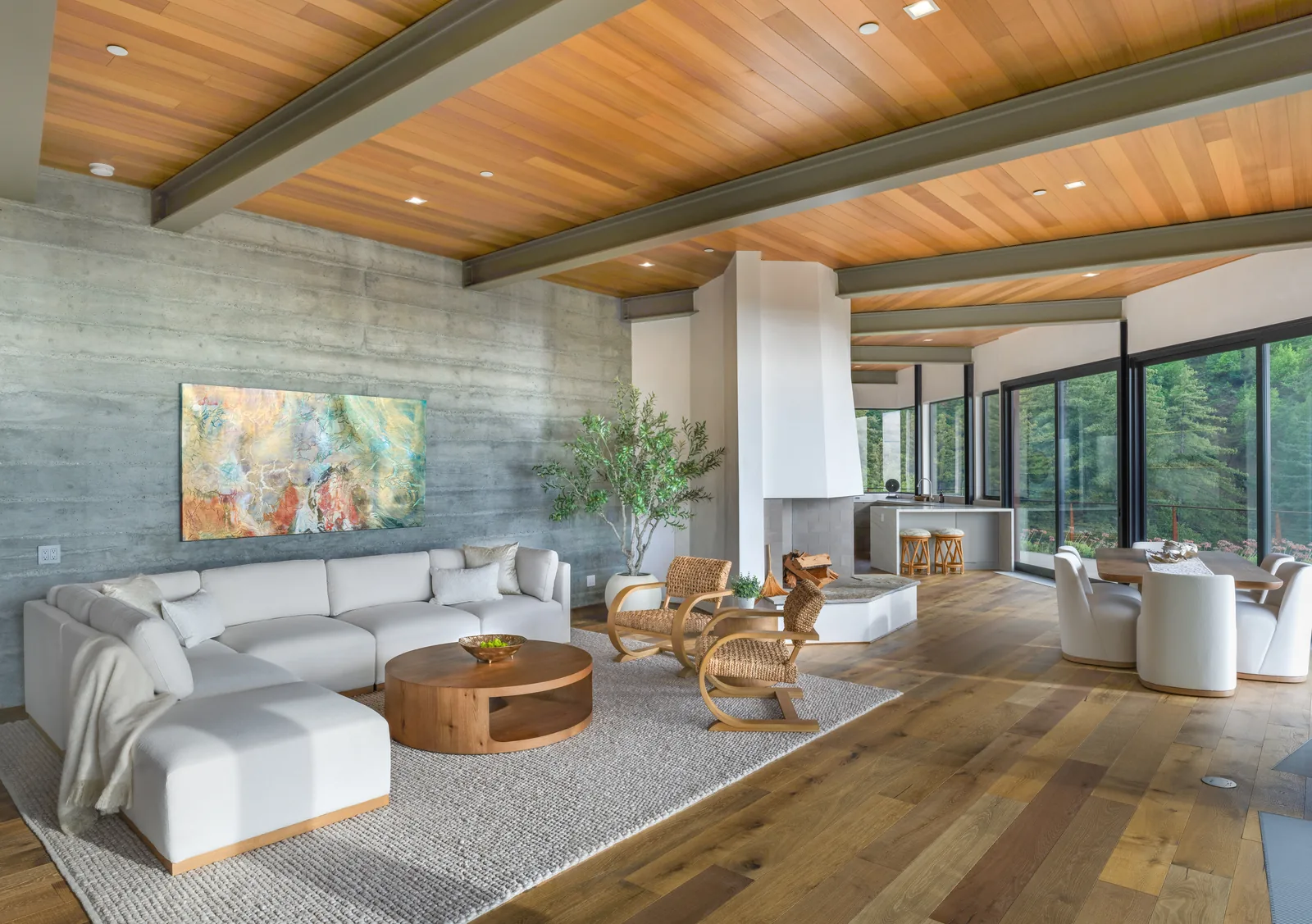 Modern great room with a wood ceiling, large artwork and ocean-view windows, interior photography by Manny Espinoza