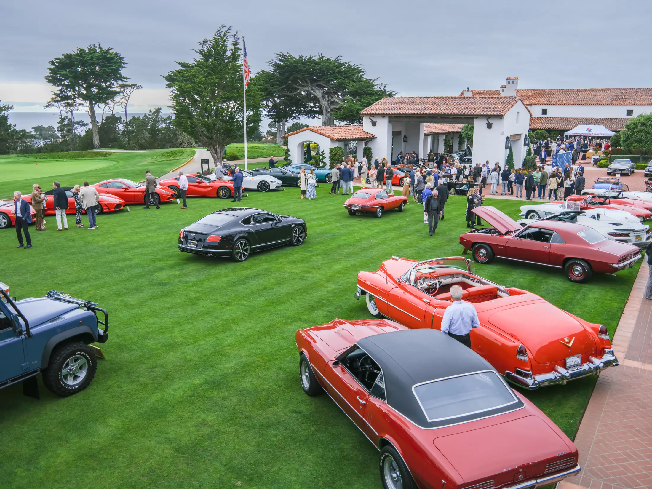 Monterey Car Week car show on the lawn at Monterey Peninsula Country Club, Ferraris and classics in front of the clubhouse, photographed by Manny Espinoza