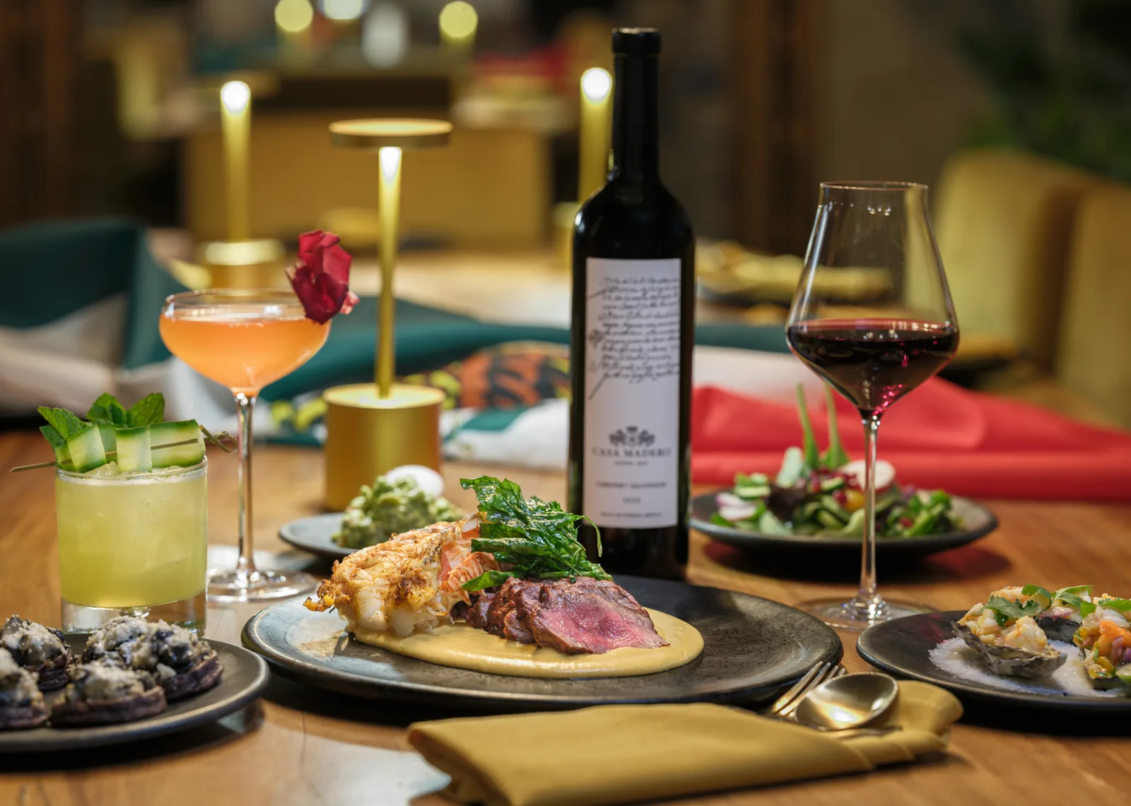 Dinner spread of steak, oysters, cocktails and wine at Nicolas in Carmel Plaza, restaurant photography by Manny Espinoza
