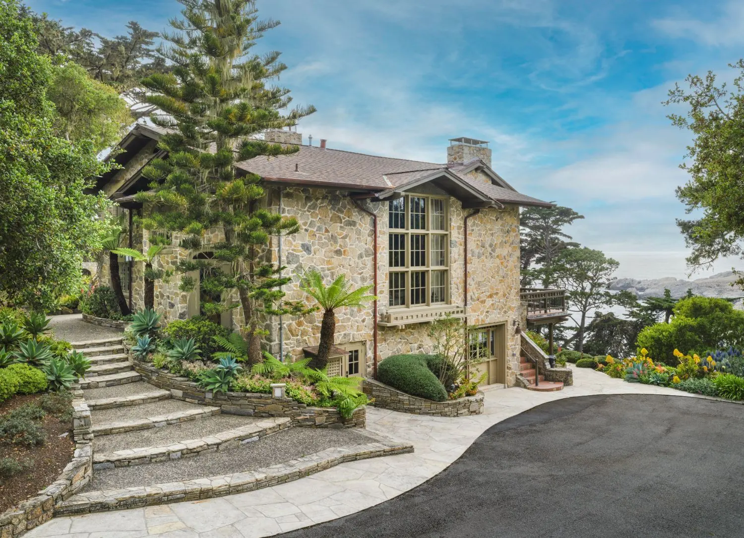 Seastone, the 1917 Carmel limestone estate attributed to Greene & Greene and regarded as the first home in the Carmel Highlands, after its restoration by Sterling | Huddleson Architecture and Carroll & Strong Builders — exterior above the Pacific, architectural photography by Manny Espinoza