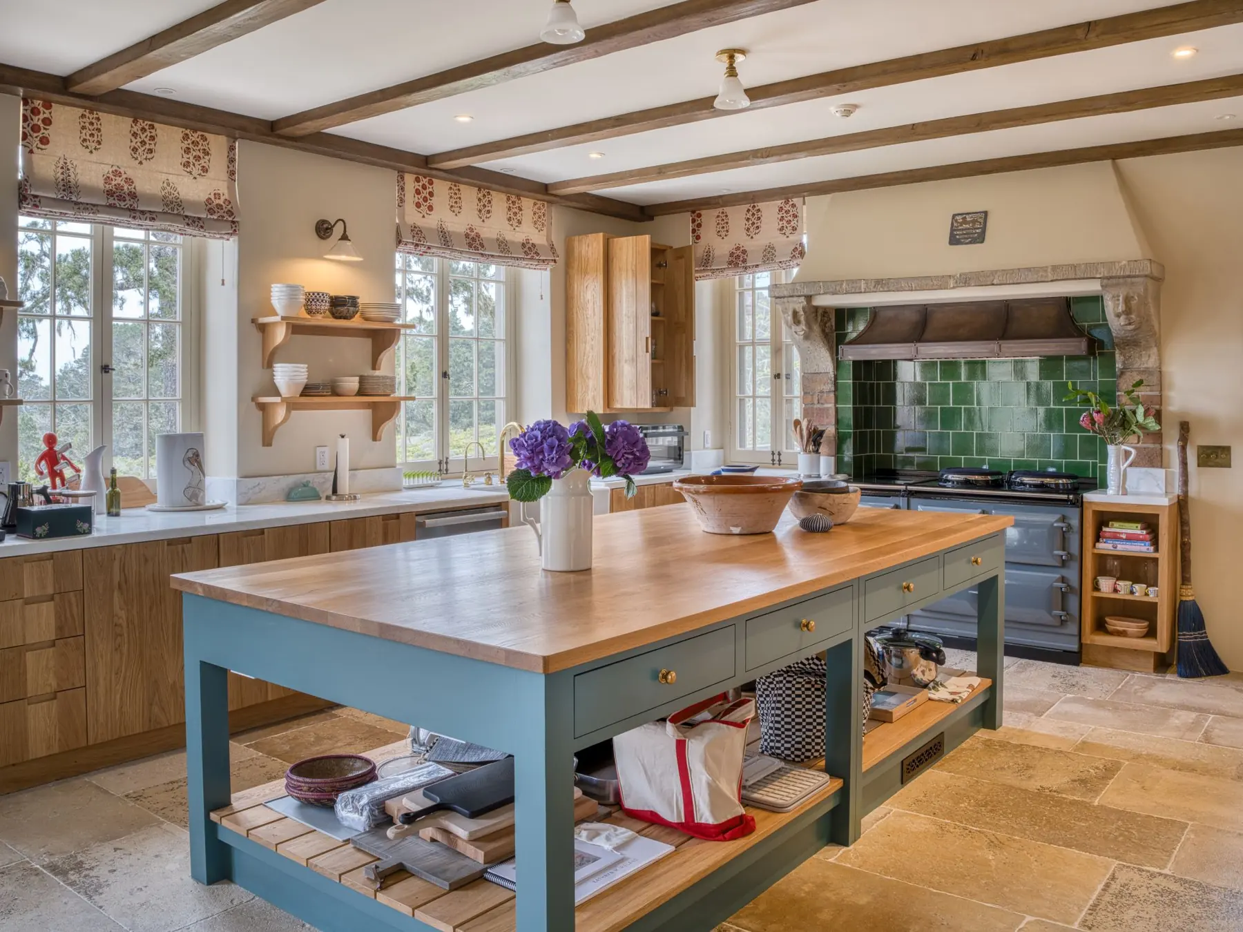 Kitchen at Seastone, Carmel Highlands, with beamed ceiling, green tile range alcove, AGA cooker and Kathryn M. Ireland fabrics — interior photography by Manny Espinoza