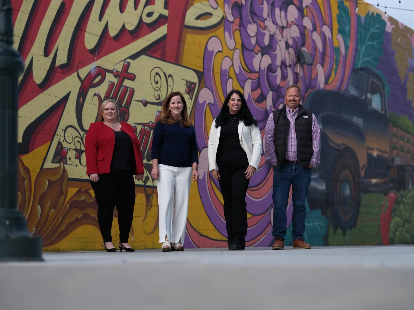 Sysco team in front of a painted mural in Oldtown Salinas, team portrait by Manny Espinoza