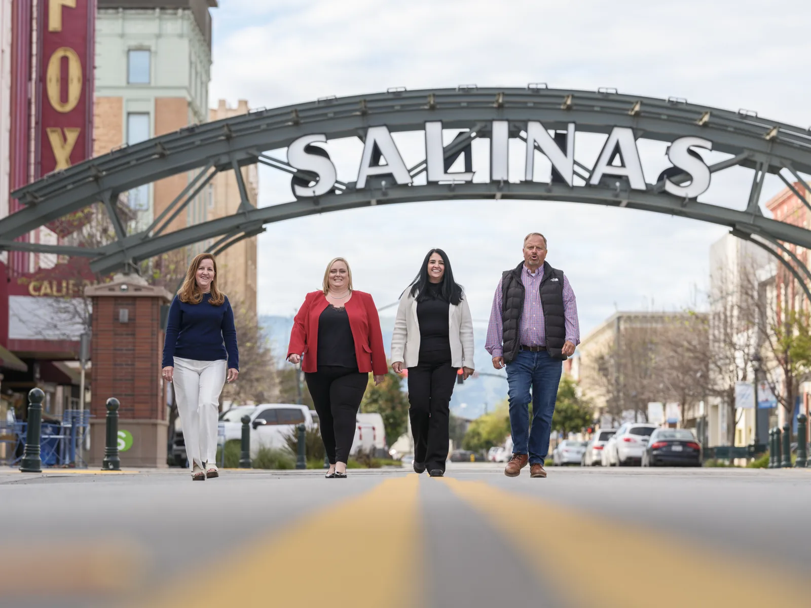 Sysco team walking down Main Street under the Salinas arch in Oldtown Salinas, team portrait by Manny Espinoza