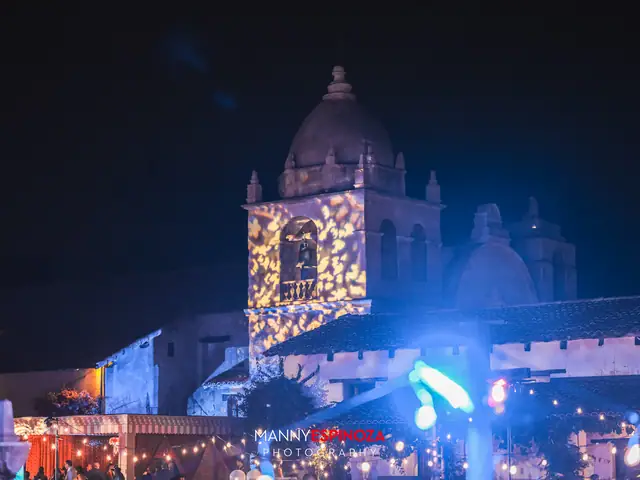 The Carmel Mission Basilica dome and bell tower illuminated at night during Taste of Carmel 2026