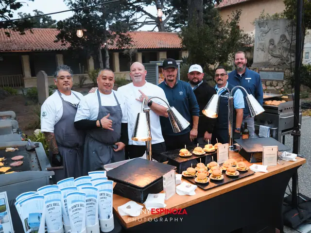 Chefs and cooks behind a food station with sliders in the Carmel Mission courtyard at Taste of Carmel 2026