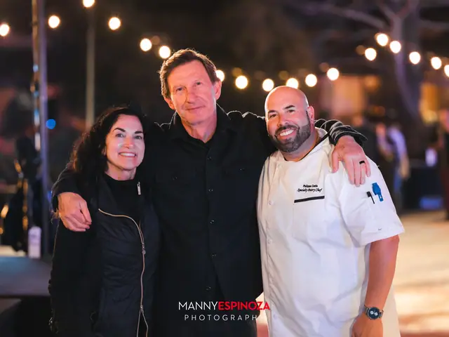 Chef in whites posing with two guests at Taste of Carmel 2026