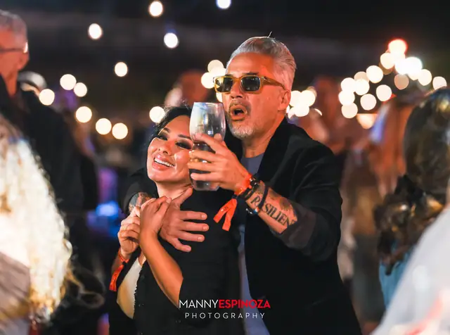 Couple dancing close together, holding a wine glass, at Taste of Carmel 2026