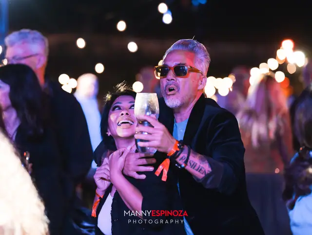 Couple dancing close together, holding a wine glass, at Taste of Carmel 2026