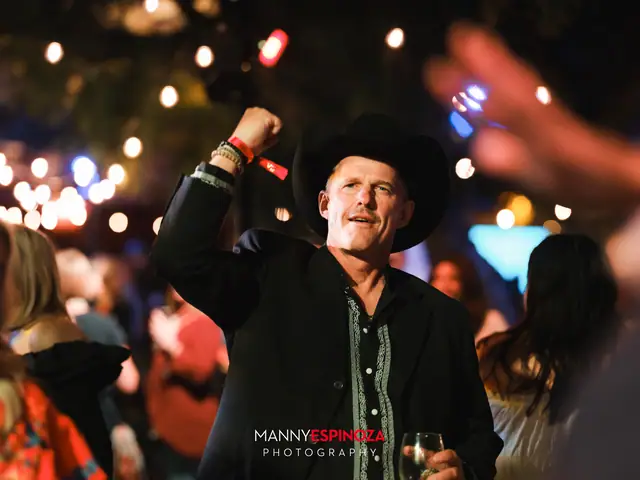 Man in a black cowboy hat cheering while dancing at Taste of Carmel 2026
