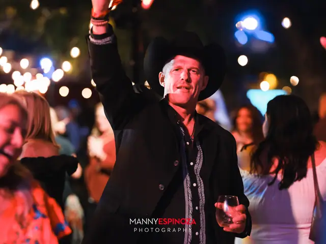 Man in a black cowboy hat cheering while dancing at Taste of Carmel 2026
