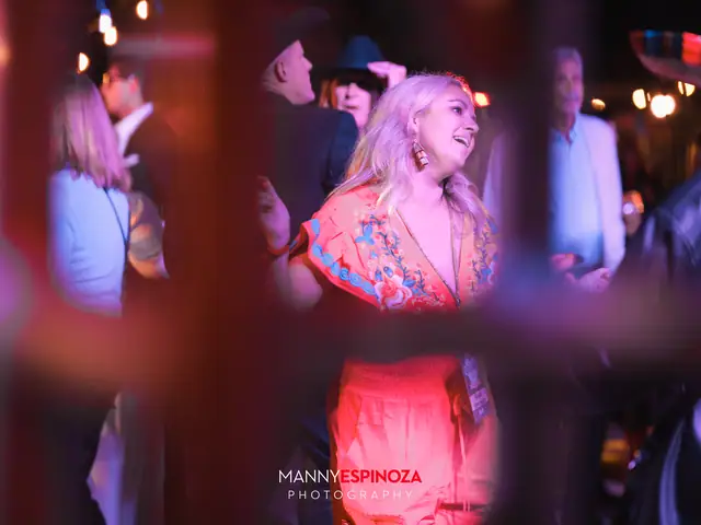Woman in an orange dress dancing in the crowd at Taste of Carmel 2026