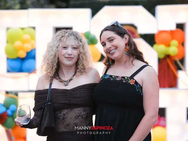 Two guests in front of the balloon-wrapped Fiesta sign at Taste of Carmel 2026