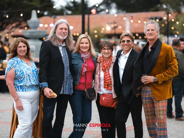 Guests posing for a portrait in the Carmel Mission courtyard at golden hour at Taste of Carmel 2026