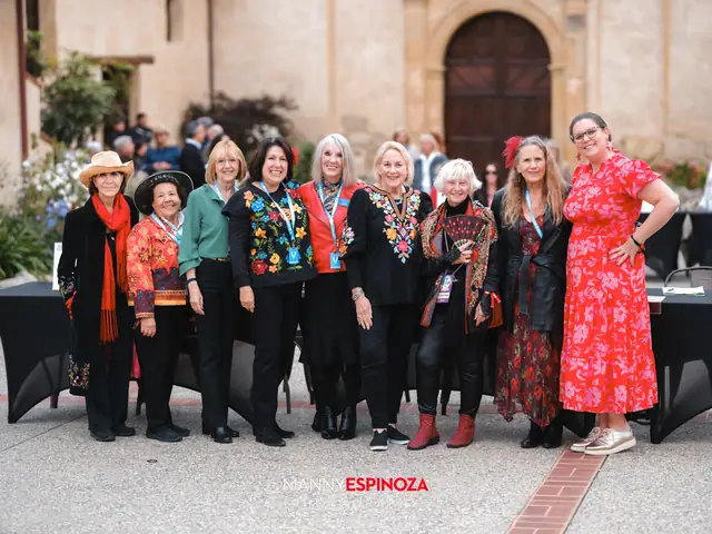 Large group of guests in colorful Fiesta outfits in front of the Carmel Mission doors at Taste of Carmel 2026