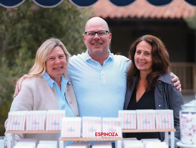 Guests posing for a portrait in the Carmel Mission courtyard at golden hour at Taste of Carmel 2026