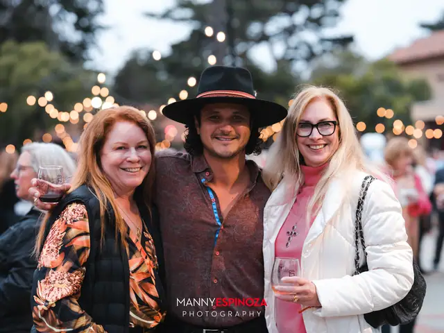 Guests posing for a portrait in the Carmel Mission courtyard at golden hour at Taste of Carmel 2026