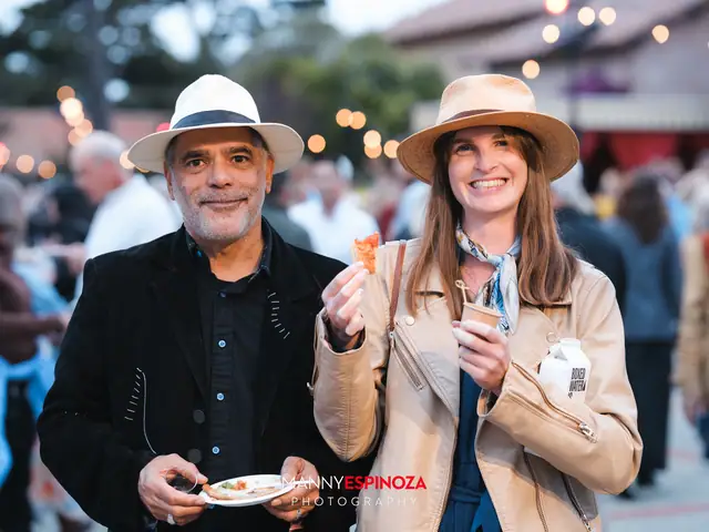Guests in sun hats sampling a bite of food at Taste of Carmel 2026
