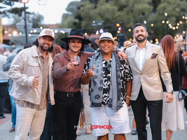 Guests posing for a portrait in the Carmel Mission courtyard at golden hour at Taste of Carmel 2026