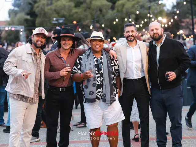 Guests posing for a portrait in the Carmel Mission courtyard at golden hour at Taste of Carmel 2026