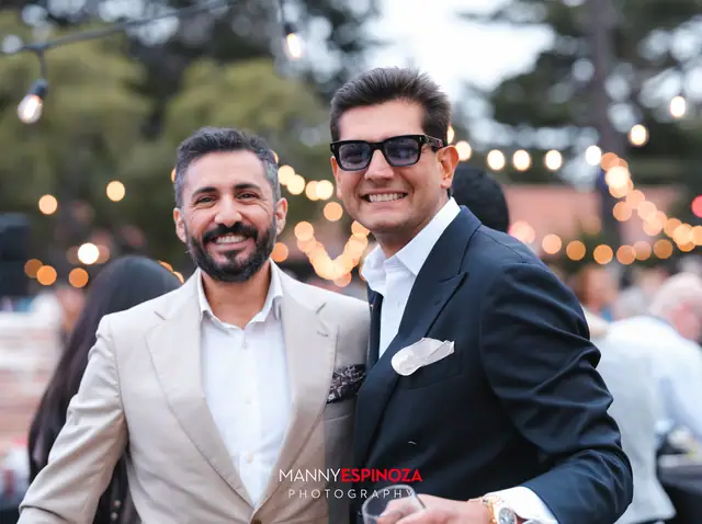Guests posing for a portrait in the Carmel Mission courtyard at golden hour at Taste of Carmel 2026