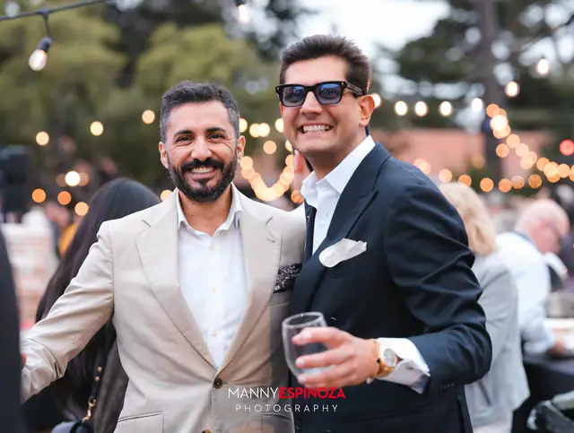 Guests posing for a portrait in the Carmel Mission courtyard at golden hour at Taste of Carmel 2026