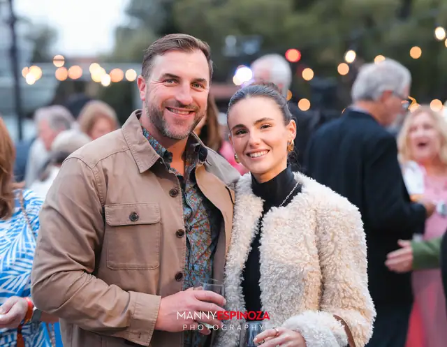 Guests posing for a portrait in the Carmel Mission courtyard at golden hour at Taste of Carmel 2026