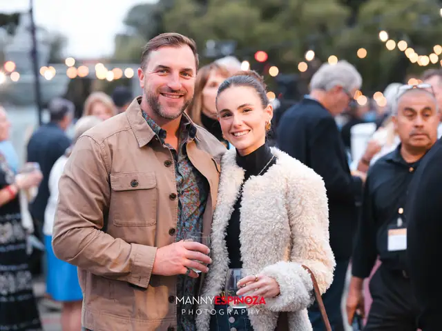 Guests posing for a portrait in the Carmel Mission courtyard at golden hour at Taste of Carmel 2026