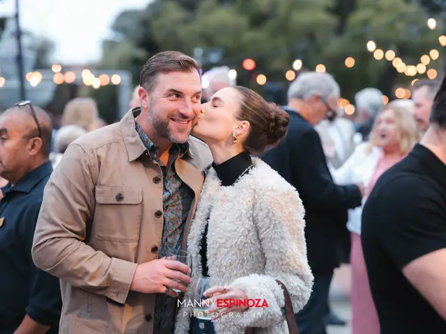 Guests posing for a portrait in the Carmel Mission courtyard at golden hour at Taste of Carmel 2026