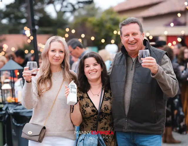 Guests posing for a portrait in the Carmel Mission courtyard at golden hour at Taste of Carmel 2026