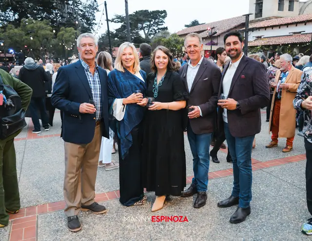 Guests posing for a portrait in the Carmel Mission courtyard at golden hour at Taste of Carmel 2026