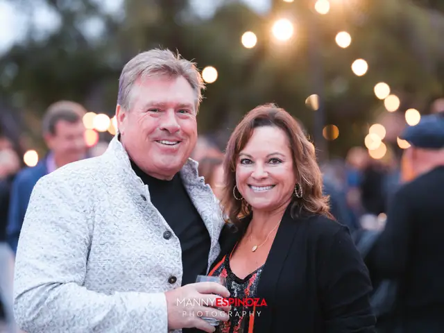 Guests posing for a portrait in the Carmel Mission courtyard at dusk at Taste of Carmel 2026
