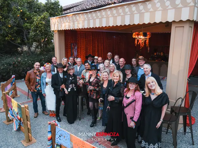 Large group photo in front of a draped stage tent at Taste of Carmel 2026