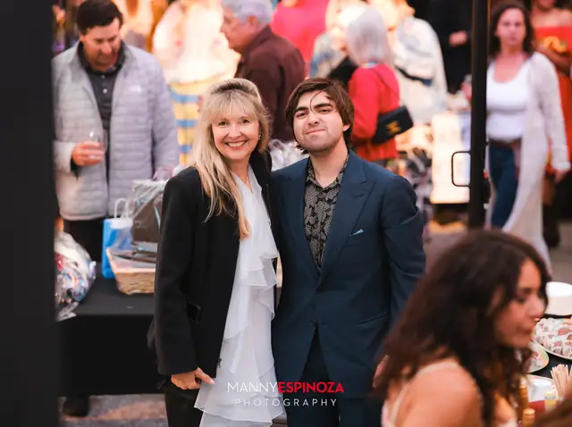 Guests posing for a portrait in the Carmel Mission courtyard at dusk at Taste of Carmel 2026