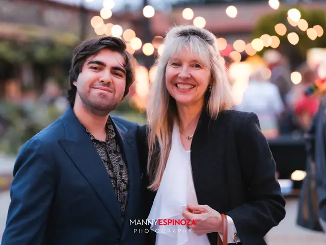 Guests posing for a portrait in the Carmel Mission courtyard at dusk at Taste of Carmel 2026