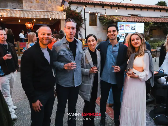 Guests posing for a portrait in the Carmel Mission courtyard at dusk at Taste of Carmel 2026