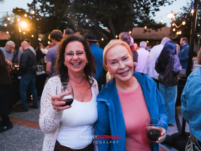 Guests posing for a portrait in the Carmel Mission courtyard at dusk at Taste of Carmel 2026