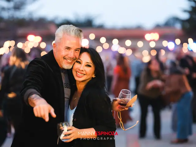 Guests posing for a portrait in the Carmel Mission courtyard at dusk at Taste of Carmel 2026