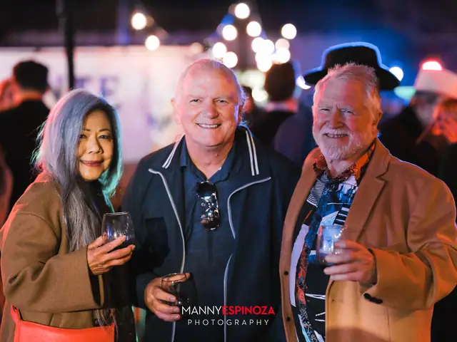 Guests posing for a portrait in the Carmel Mission courtyard at night at Taste of Carmel 2026