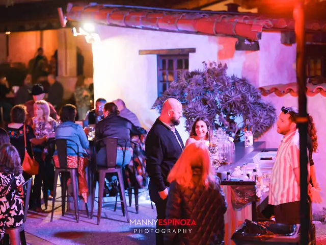 Guests at an outdoor bar glowing in red light at Taste of Carmel 2026