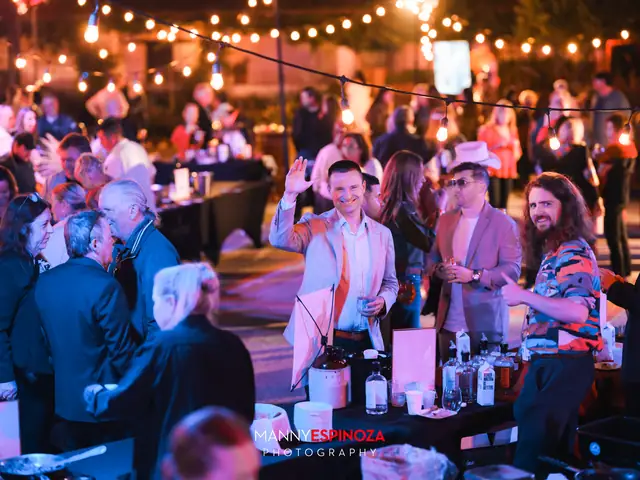 Guests gathered around a tasting table under string lights at night at Taste of Carmel 2026